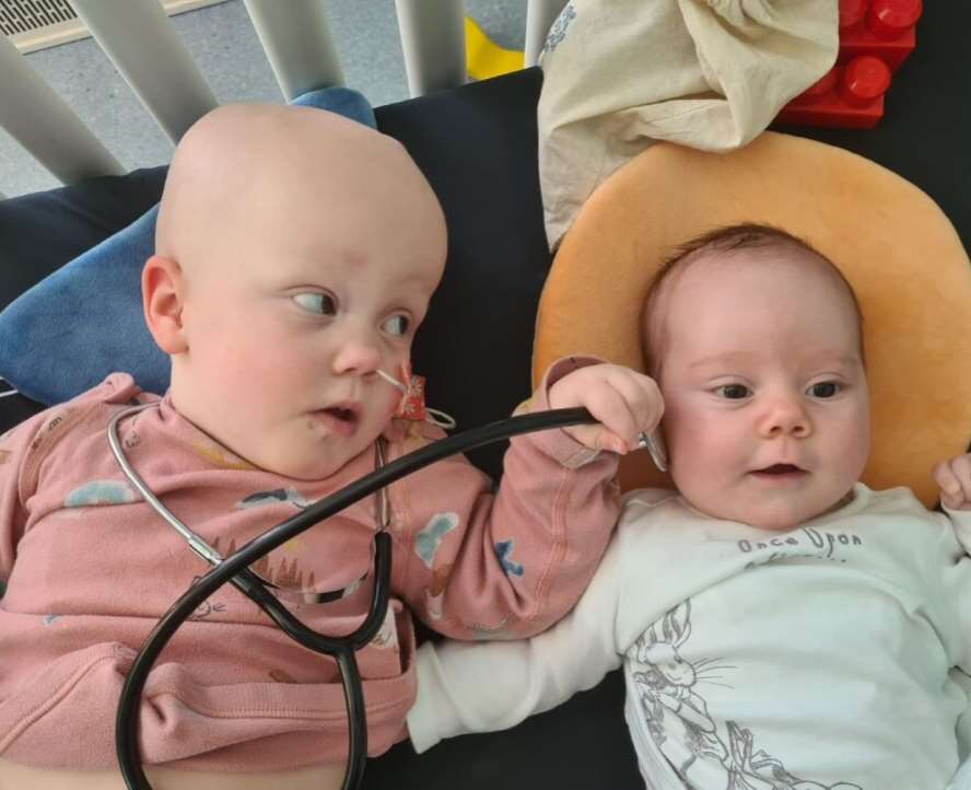 Sky, with sister Bo, loved seeing the doctors with stethoscopes during her time in hospital (Handout/PA)